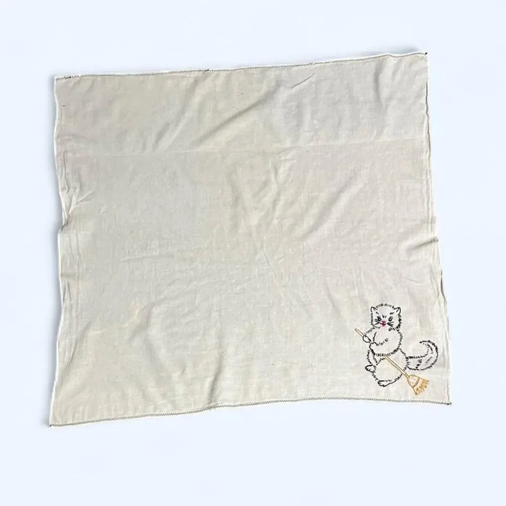 Hand embroidered thin linen hand towel or small tablecloth with a cat and broom